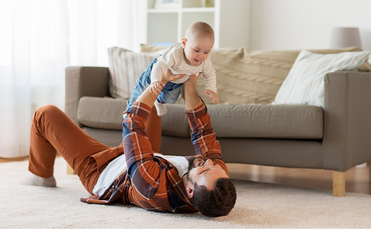 parent and baby playing on carpet baby safe floors